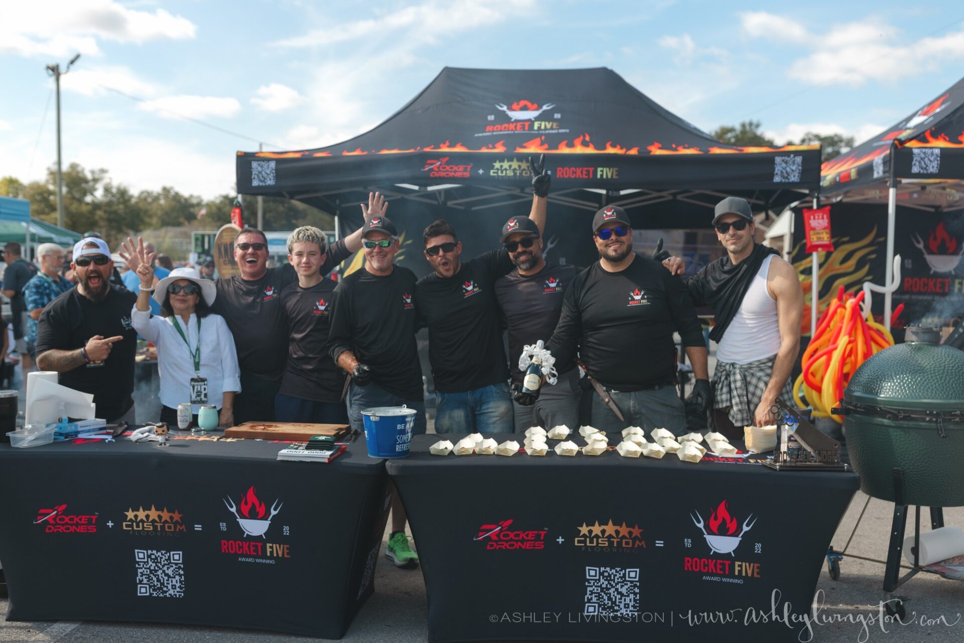 Cook team celebrating at their tent with a Big Green Egg grill during Pensacola EggFest 2025